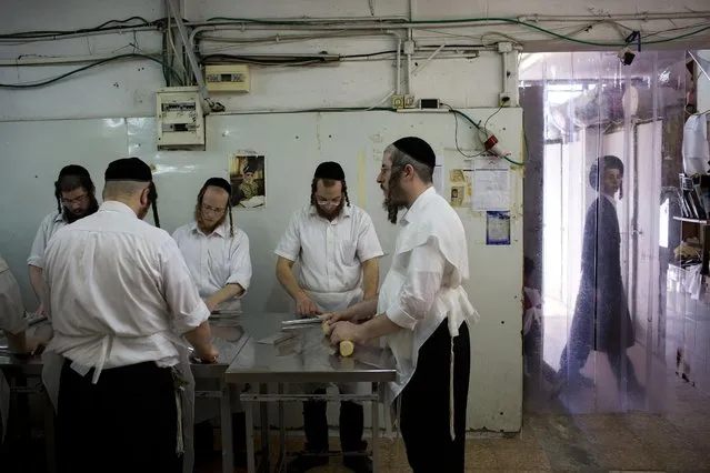 Ultra-Orthodox Jews prepare special matzoh, a traditional handmade Passover unleavened bread, at a bakery in Bnei Brak near Tel Aviv, Israel, Tuesday, March 31, 2015. (Photo by Oded Balilty/AP Photo)