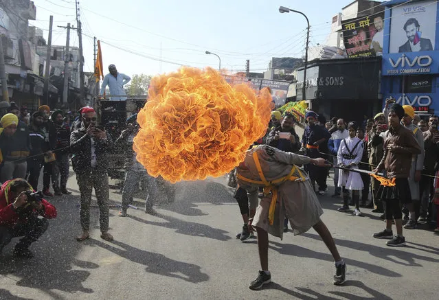 In this Thursday, January 3, 2019, file photo, an Indian Sikh warrior blows fire as he displays traditional martial art skills during a religious procession ahead of the birth anniversary of Guru Gobind Singh in Jammu, India. The birth anniversary of Guru Gobind Singh, the tenth Sikh guru, will be marked on Jan. 5. (Photo by Channi Anand/AP Photo)