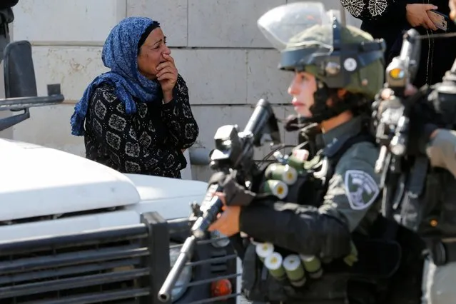A Palestinian woman reacts during clashes as Israeli machinery demolish Palestinian houses near Hebron in the Israeli-occupied West Bank, August 5, 2021. (Photo by Mussa Qawasma/Reuters)
