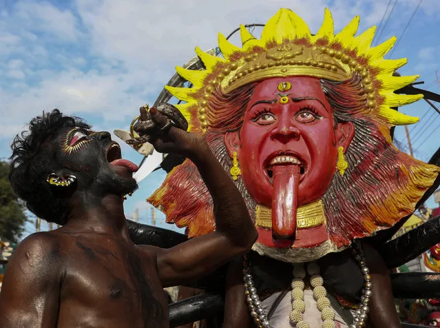 A man performs with a Python during a procession as part of “Bonalu” festival in Hyderabad, India, Monday, August 2, 2021. (Photo by Mahesh Kumar A./AP Photo)