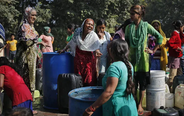 Residents wait to collect water from a municipal tanker in New Delhi, India, February 22, 2016. The Indian army has taken control of a canal that supplies three-fifths of Delhi's water, the state's chief minister said on Monday, raising hope that a water crisis in the metropolis of more than 20 million people can be averted. (Photo by Anindito Mukherjee/Reuters)
