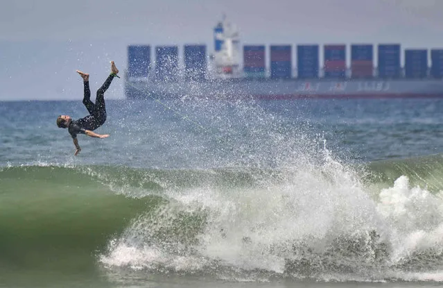 A surfer wipes out, north of the pier in Huntington Beach, Calif,  Thursday, August 19, 2021. (Photo by Jeff Gritchen/The Orange County Register via AP Photo)