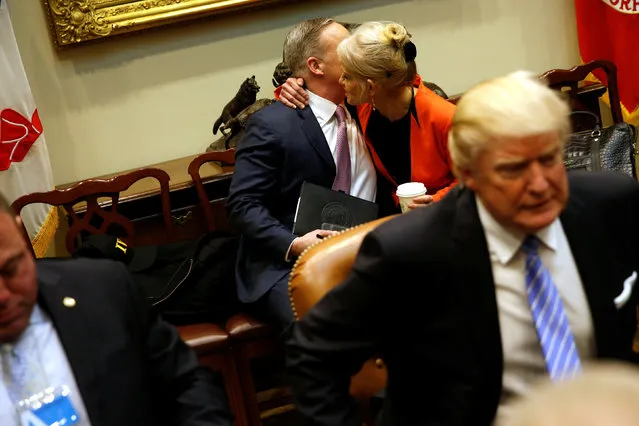White House Senior Advisor Kellyanne Conway (2nd R) embraces Communications Director Sean Spicer  as he joins a roundtable discussion between U.S. President Donald Trump and labor leaders, after Spicer's first press briefing at the White House in Washington, U.S. January 23, 2017. (Photo by Jonathan Ernst/Reuters)