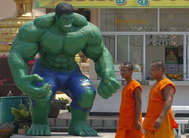 Buddhist monks walk past a statue of comic character the Hulk at Tamru temple in Samut Prakan province, Thailand, March 3, 2016. (Photo by Chaiwat Subprasom/Reuters)