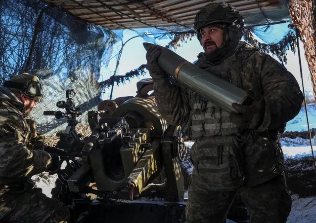 Ukrainian service members of 79th brigade fire a L119 howitzer towards Russian troops near the front line town of Marinka, amid Russia's attack on Ukraine, in Donetsk region, Ukraine on January 12, 2024. (Photo by Oleksandr Ratushniak/Reuters)