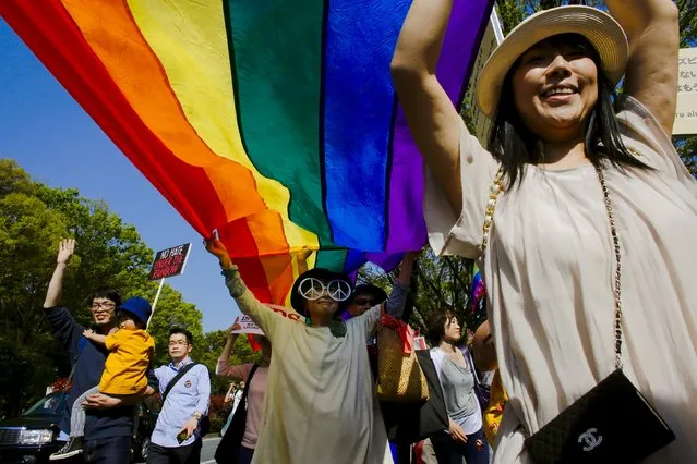 Participants hold a rainbow flag during the Tokyo Rainbow Pride parade in Tokyo April 26, 2015. Thousands of lesbians, gays, bisexuals, transgenders (LGBT) and their supporters participated in the parade on Sunday to celebrate LGBT lifestyle and denounce prejudice and discrimination against sexual minorities. (Photo by Thomas Peter/Reuters)
