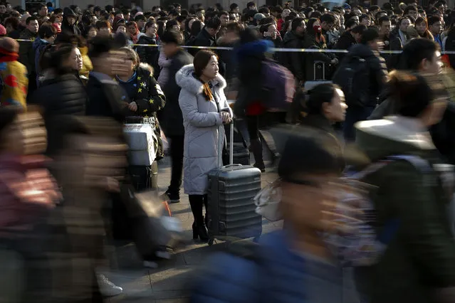 Passengers crowd outside the Beijing railway station on the last day of Chinese Lunar New Year holidays in Beijing, Thursday, February 2, 2017. Millions of Chinese are returning to work in the capital city after spending a week-long Lunar New Year holiday with families in their hometown. (Photo by Andy Wong/AP Photo)