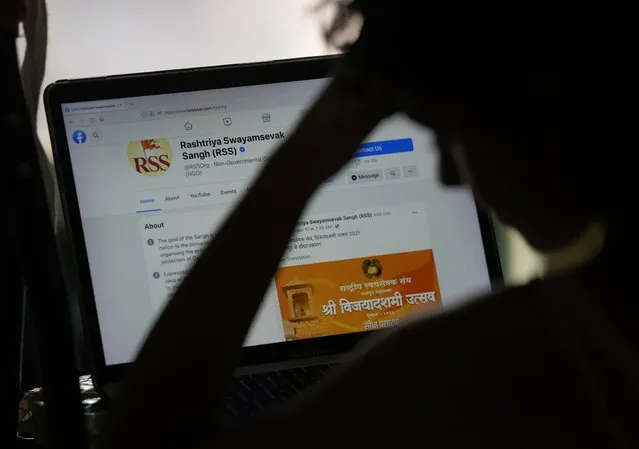 A girl looks at the face book page of Rashtriya Swayamevak Sangh or RSS, in New Delhi, India, Sunday, October 24, 2021. Facebook in India has been selective in curbing hate speech, misinformation and inflammatory posts, particularly anti-Muslim content, according to leaked documents obtained by The Associated Press, even as the internet giant's own employees cast doubt over the motivations and interests. (Photo by Manish Swarup/AP Photo)