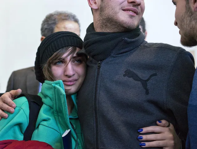 Sarah Assali, 19, left, who just arrived from Syria, is embraced by her brother Tawfik Assali, 21, of Allentown, Pa., upon her and other family members' arrival from Syria at Terminal at John F. Kennedy International Airport in New York, Monday, February 6, 2017. Attorneys said Dr. Assali's brothers, their wives and their two teenage children returned to Syria after they were denied entrance to the United States on Jan. 28 although they had visas in hand after a 13-year effort. (Photo by Craig Ruttle/AP Photo)