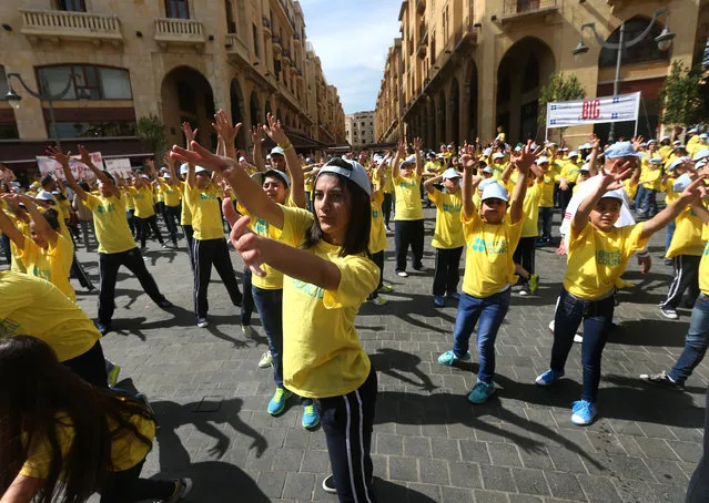 Lebanese students dance during the event The Big Dance “Beats for Peace”, at the Parliament square, in downtown Beirut, Lebanon, Saturday, May 9, 2015. About 1000 students from all over Lebanon gather and take part in a joint dance with the aim of encouraging people to get into dance and increase fitness levels. (Photo by Hussein Malla/AP Photo)