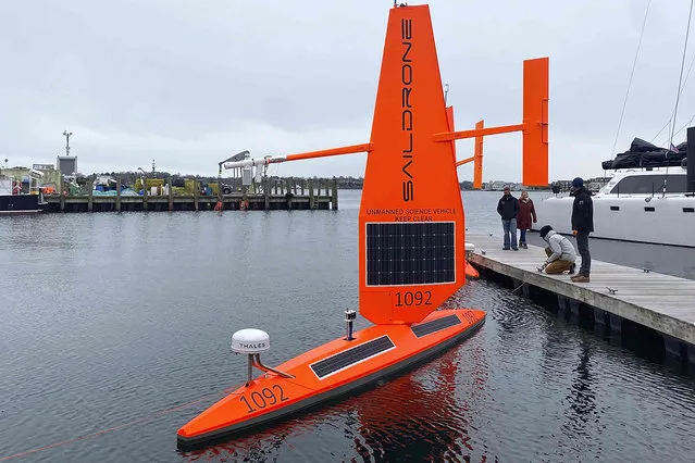 A Saildrone Explorer un-crewed surface vehicle, or ocean drone, is prepared for launch at a dock, in Newport, R.I., Wednesday, December 8, 2021. Three of the drones are to be launched, Thursday, Dec. 9, 2021, and are expected to travel along the Gulf Stream, collecting data in tough winter conditions that would be challenging for traditional ships with crews. Saildrone, headquartered in Alameda, Calif., makes autonomous surface vehicles powered by the wind and sun to measure climate quality data and do mapping in remote oceans for scientists worldwide. (Photo by Susan Ryan/Saildrone via AP Photo)