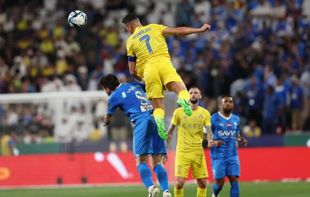 Cristiano Ronaldo (Top) of Al-Nassr in action against Ruben Neves of Al-Hilal during the semifinal soccer match of the Saudi Super Cup between Al-Hilal and Al-Nassr in Abu Dhabi, United Arab Emirates, 08 April 2024.  (Photo by Ali Haider/EPA)