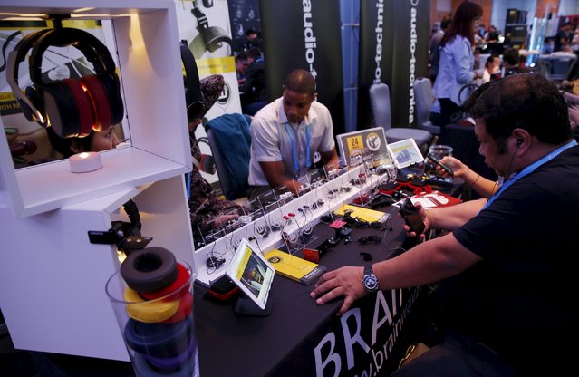 People test earphones and headphones during the CanJam headphone and personal audio expo in Singapore February 21, 2016. (Photo by Edgar Su/Reuters)