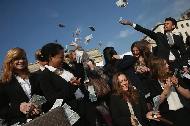 Activists wearing suits throw fake money into the air while demanding greater trasparency in new legislation following the ongoing Panama Papers affair on April 13, 2016 in Berlin, Germany. Police in Panama have reportedly raided the offices of Mossack Fonseca, the law-firm accused of facilitating large-scale offshore tax evasion for thousands of its clients. (Photo by Sean Gallup/Getty Images)