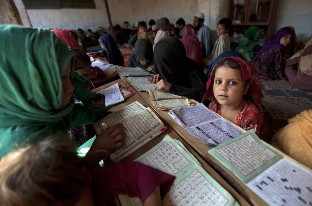 Internally displaced Pakistani children from tribal areas attend their daily lesson at a madrassa, a school for the study of Islam, on the outskirts of Islamabad, Pakistan, Monday, April 6, 2015. (Photo by B. K. Bangash/AP Photo)