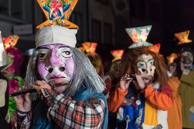 Revellers wearing masks and lanterns parade through the streets during the so-called “Morgestraich” in Basel, Switzerland, on early Monday morning, 06 March 2017. The traditional “Morgestraich” starting at 4 a.m. is the kick-off for the carnival of Basel. (Photo by Georgios Kefalas/EPA)