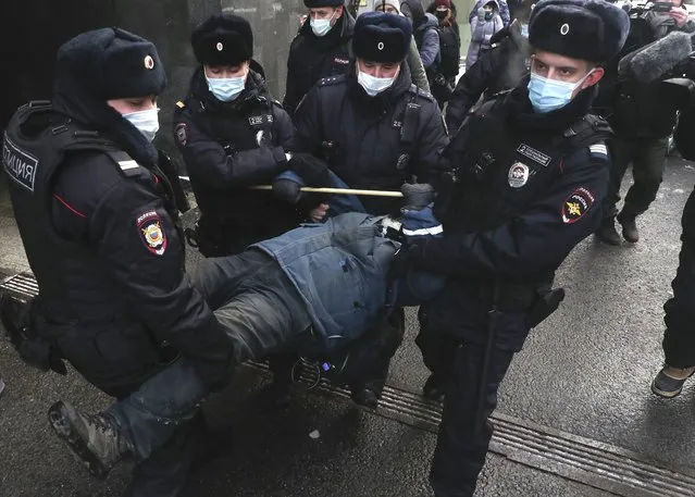 Police officers detain a demonstrator as people gather in front of the Supreme Court of the Russian Federation, in Moscow, Russia, Tuesday, December 28, 2021. Russia’s Supreme Court has ruled that one of the country’s oldest and most prominent human rights organizations should be shut down. The move is the latest step in a months-long crackdown on dissent. The Prosecutor General’s Office last month petitioned the Supreme Court to revoke the legal status of Memorial – an international human rights group that rose to prominence for its studies of political repression in the Soviet Union. (Photo by AP Photo/Stringer)