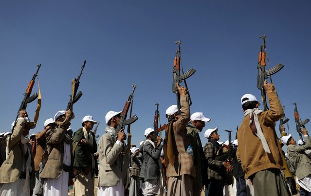 Armed Houthi followers hold up rifles as they take part in a parade during a protest to decry the U.S.-led strikes on Houthi targets and to show support to Palestinians in the Gaza Strip, amid the ongoing conflict between Israel and the Palestinian Islamist group Hamas, near Sanaa, Yemen on January 25, 2024. (Photo by Khaled Abdullah/Reuters)