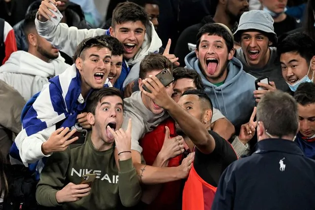 Nick Kyrgios of Australia takes selfies with spectators after winning his first round Men’s singles match against Liam Broady of Britain on Day 2 of the Australian Open, at Melbourne Park, in Melbourne, Australia, 18 January 2022. (Photo by Dave Hunt/EPA/EFE)