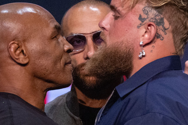 Former US boxer Mike Tyson (L) and YouTuber Jake Paul face off during a press conference at the Apollo Theatre in New York, on May 13, 2024. Former heavyweight boxing champion Mike Tyson's July 20 fight against YouTube sensation Jake Paul in Dallas will be a sanctioned heavyweight professional bout, fighters and promoters announced on April 29. The fight will be over eight two-minute rounds with the result to count on the record of both Paul and Tyson, who lost his last official bout in 2005. (Photo by Kena Betancur/AFP Photo)
