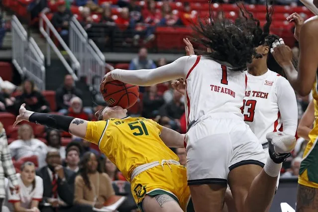 Texas Tech's Ella Tofaeono (1) fouls Baylor's Caitlin Bickle (51) by hitting the ball in her face during the first half of an NCAA college basketball game on Wednesday, January 26, 2022, in Lubbock, Texas. (Photo by Brad Tollefson/AP Photo)