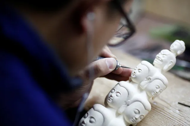 A man carves ivory at a workshop in Beijing, China, March 31, 2017. (Photo by Thomas Peter/Reuters)