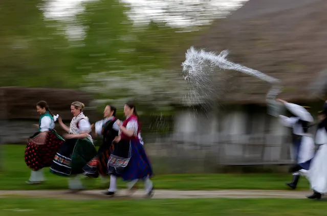 Women run as men throw water at them as part of traditional Easter celebrations in Szenna, Hungary April 14, 2017. (Photo by Laszlo Balogh/Reuters)