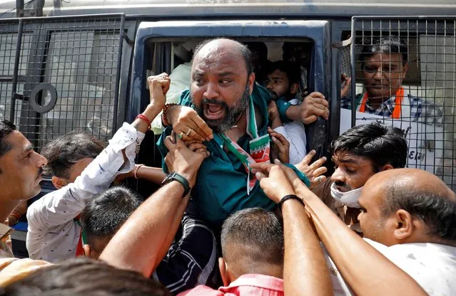 A supporter of India's main opposition Congress party shouts from a police vehicle as he is detained during a protest against the rise in fuel prices, in Ahmedabad, India, April 1, 2022. (Photo by Amit Dave/Reuters)