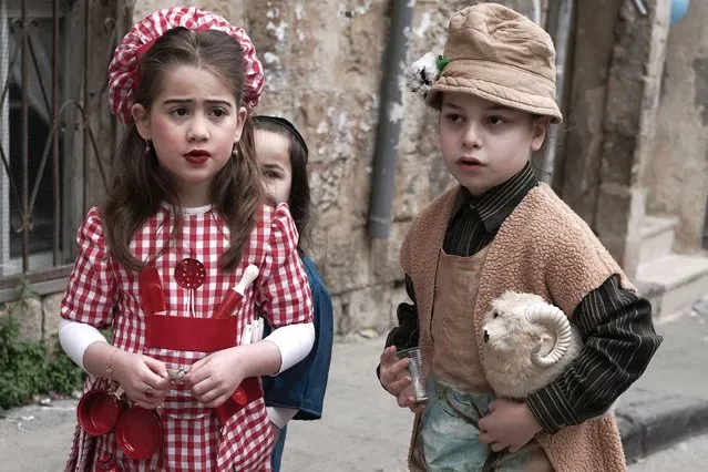 Children in costumes on Purim in Jerusalem's ultra Orthodox neighborhood of Meah Shaarim on March 18, 2022. Purim is one of Judaism's more colorful and popular holidays, commemorating the events described in the Book of Esther and particularly the miraculous salvation of the Jews in ancient Persia. (Photo by Nir Alon/ZUMA Press Wire/Rex Features/Shutterstock)