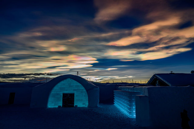 A phenomenon called Polar stratospheric clouds (PSCs) appears over Icehotel 34 on December 17, 2023 in Jukkasjarvi, Sweden. Since 1989, the Icehotel – part hotel, part art exhibition – has been crafted annually from ice taken from the Torne River. (Photo by Roy Rochlin/Getty Images)