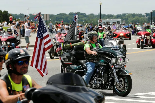 People line the route as motorcyclists participate in the Rolling Thunder motorcycle rally, the annual ride around Washington Mall to raise awareness for prisoners of war and soldiers still missing in action, on Memorial Day weekend in Washington, U.S., May 29, 2016. (Photo by Jonathan Ernst/Reuters)