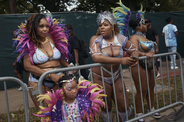 Revelers gather during the West Indian Day Parade on Monday, September 2, 2024, in the Brooklyn borough of New York. (Photo by Andres Kudacki/AP Photo)