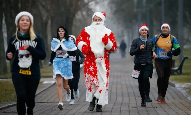 Belarusians dressed as Santa Clauses take part in the country's Santa Run in Minsk, Belarus on December 14, 2019. (Photo by Vasily Fedosenko/Reuters)