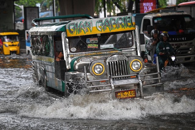 A passenger jeepney commutes through a flooded street in Manila on September 5, 2024, caused by heavy rains due to the southwest monsoon influenced by Tropical Storm Yagi which hit the main island of Luzon on September 2. (Photo by Ted Aljibe/AFP Photo)