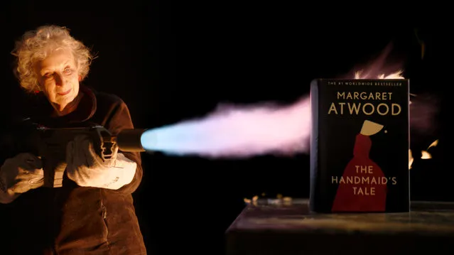 Undated handout photo issued by Sotheby's of the Canadian author, Margaret Atwood's, 82, donning black safety gloves and blasting the one-of-a-kind “unburnable” edition of The Handmaid's Tale, with a flamethrower to test its fire-resistance. Issue date: Wednesday, June 8, 2022. (Photo by Sotheby's/PA Wire)