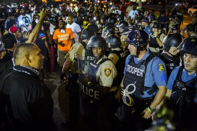 St Louis County police officers interact with anti-police demonstrators during protests in Ferguson, Missouri August 10, 2015. (Photo by Lucas Jackson/Reuters)