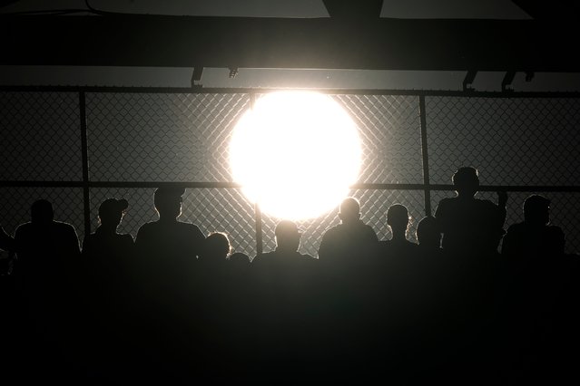 Fans watch of Game 1 of a baseball NL Division Series between the Philadelphia Phillies and the New York Mets as the sun sets, Saturday, October 5, 2024, in Philadelphia. (Photo by Matt Slocum/AP Photo)