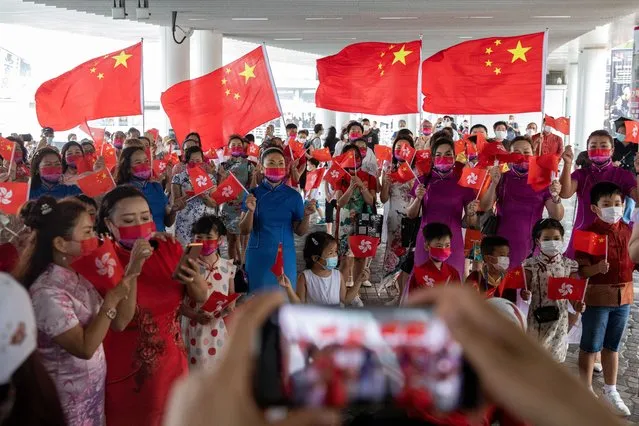 Supporters of China sing patriotic songs and wave flags in Hong Kong, China, 01 July 2022. The Chinese president is visiting the city to mark the 25th Anniversary of the establishment of the Hong Kong Special Administrative Region (HKSAR) of the People’s Republic of China. (Photo by Jerome Favre/EPA/EFE)