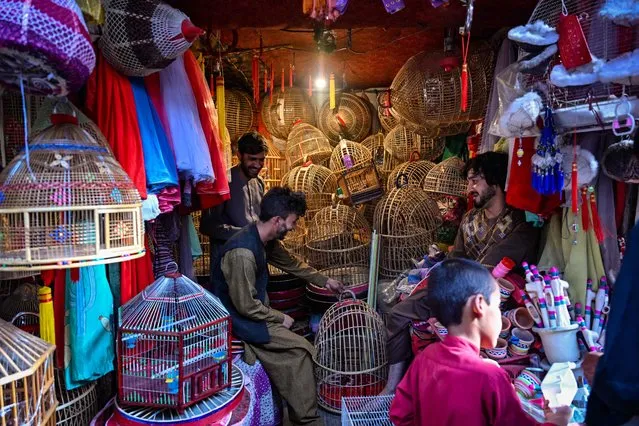 Vendors prepare bird cages in the Ka Faroshi bird market in Kabul on July 16, 2022. (Photo by Lillian Suwanrumpha/AFP Photo)