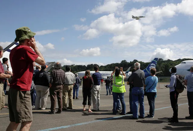Boeing employees and guests watch historic aircraft flyby at an event marking the centennial of The Boeing Company in Seattle, Washington July 15, 2016. (Photo by Jason Redmond/Reuters)