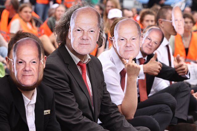 Activists wear masks showing the face of German Chancellor Olaf Scholz as they sit on a street during a protest march of the Last Generation climate activism group in Berlin, Germany, 13 September 2023. According to the climate activists, they will again start blocking streets in various towns in Germany to protest against the government's lack of plan and what they claim to be a 'breach of law' in the climate crisis. (Photo by Clemens Bilan/EPA)