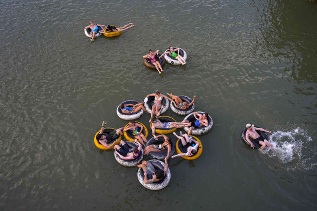 Foreign tourists float on tubes in a river in Vang Vieng, Laos, Tuesday, November 19, 2024. (Photo by Anupam Nath/AP Photo)