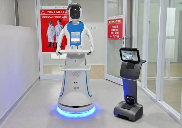 This China-made robot called Amy (L) and US-made called Temi (R) are seen during a simulation to assist medical team in handling patients with the COVID-19 coronavirus at the Pertamina Jaya hospital in Jakarta on April 16, 2020. (Photo by Adek Berry/AFP Photo)