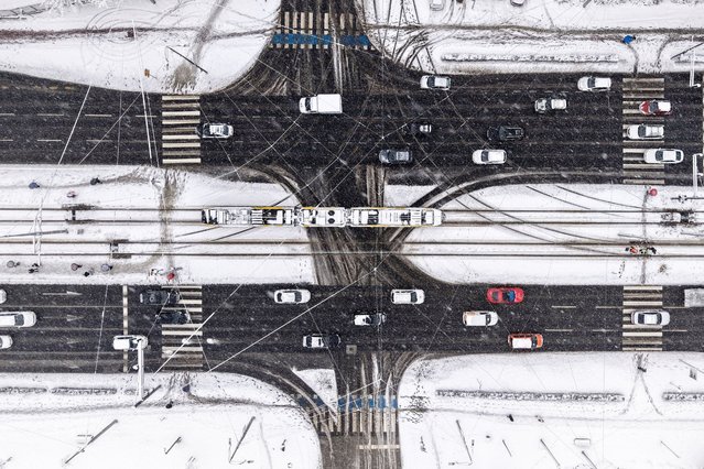 An aerial view of the city traffic during heavy snowfall in Sarajevo, Bosnia, Tuesday, December 24, 2024. (Photo by Armin Durgut/AP Photo)