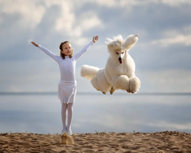 Nine year old Maria Palkina dancing with dogs. (Photo by Andrey Seliverstov/Caters News Agency)