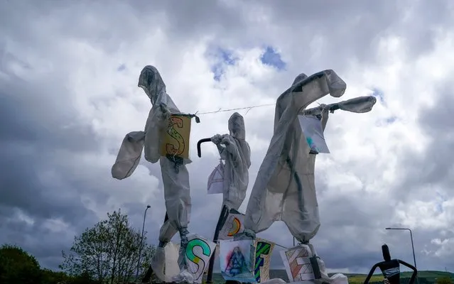 A statue entitled “The Workers” which is covered in personal protection equipment (PPE), is erected on a traffic island during the pandemic lockdown on May 11, 2020 in Haslingden, United Kingdom. The Prime Minister announced the general contours of a phased exit from the current lockdown, adopted nearly two months ago in an effort curb the spread of Covid-19. (Photo by Christopher Furlong/Getty Images)