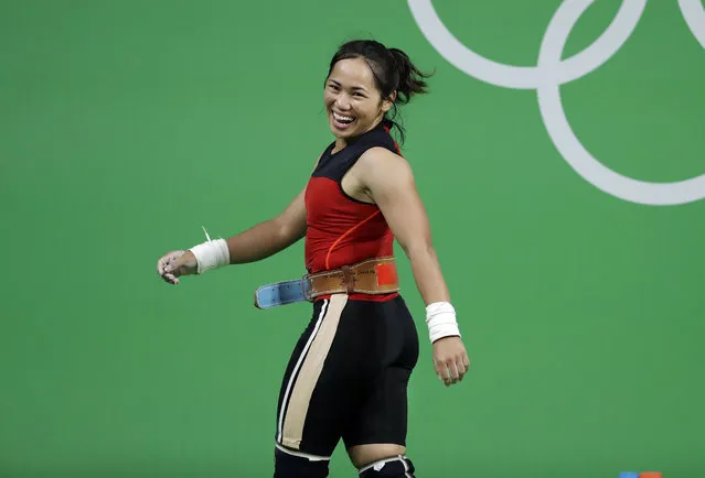 Hidilyn Diaz, of the Philipines, laughs as she leaves the stage after a lift in the women's 53kg weightlifting competition at the 2016 Summer Olympics in Rio de Janeiro, Brazil, Sunday, August 7, 2016. (Photo by Mike Groll/AP Photo)