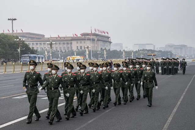 People's Liberation Army soldiers march along a road at the end of the flag raising ceremony during National Day in Beijing, China, on Saturday, October 1, 2022. Beijing's Covid Zero strategy remains a major threat to growth, with key cities like Chengdu only recently emerging from lockdowns. Tourism has been decimated and travel during the upcoming National Day holidays in October is being discouraged. (Photo by Bloomberg)