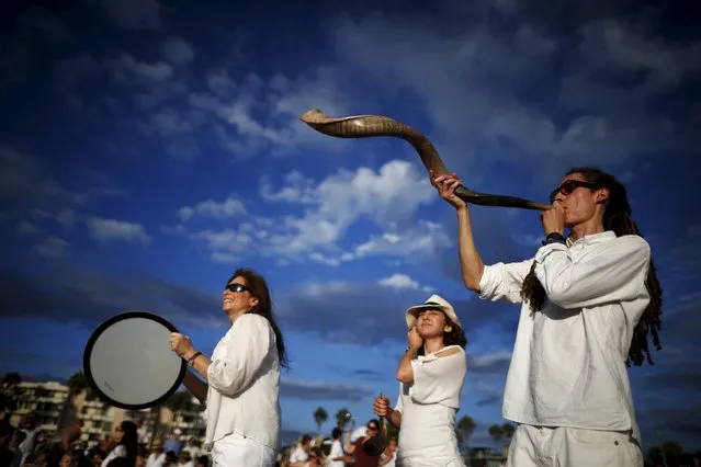 Jared Stein, 29, (R) blows a shofar as Rabbi Naomi Levy (L) plays a drum at the Nashuva Spiritual Community Jewish New Year celebration on Venice Beach in Los Angeles, California, United States September 14, 2015. (Photo by Lucy Nicholson/Reuters)