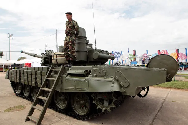 A soldier stands on a Russian-made T-72 tank during the Static Military Civic Exhibition in Managua, Nicaragua August 17, 2016. (Photo by Oswaldo Rivas/Reuters)
